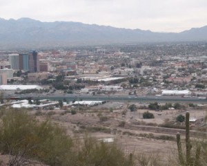 Center just right of downtown is the Tucson Convention Center.  On the left is the GJX or Gem & Jewelry Exchange tent.  On the right is the JG&M Expo tent.  In the foreground is teh riverpark Inn on the near side of the freeway.