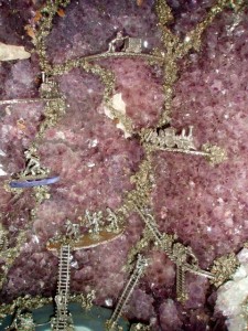 Some had glued little miners, tracks, trains and other things to the inside of a large Amethyst geode.