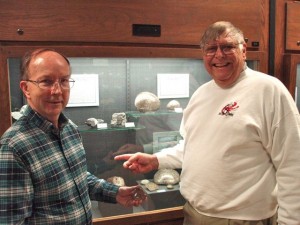 Donating my Pink Petoskey Stone to Dr. Robinson at the Seaman Museum. I am pointing the case where the specimen should fit.