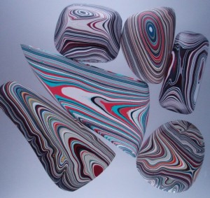 A new supply Fordite cabochons ready for jewelry.