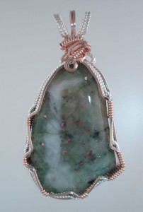 I expect this is Prehnite with Copper Inclusions is similar to the Patricianite we find in the Keweenaw.
