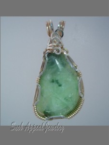 Prehnite with Copper. This is the high quality stuff often found in slim seams.