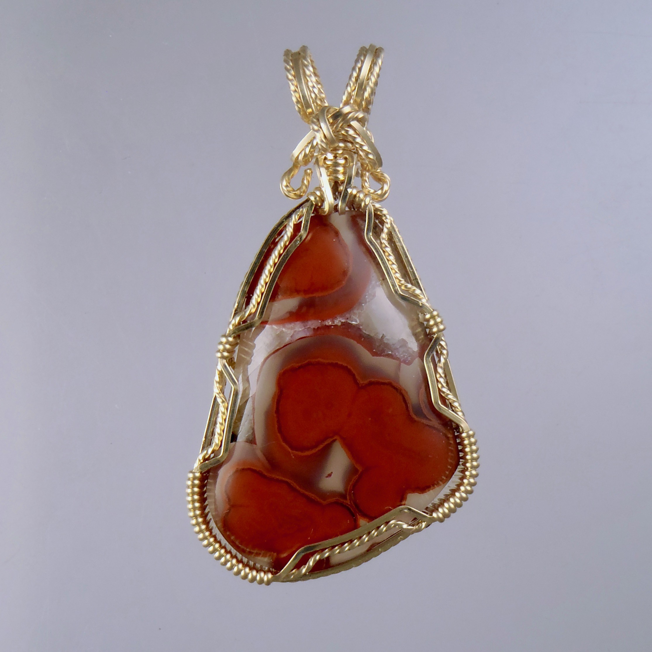 Yellow Cat River Petrified Wood shows bright red in clear quartz pools